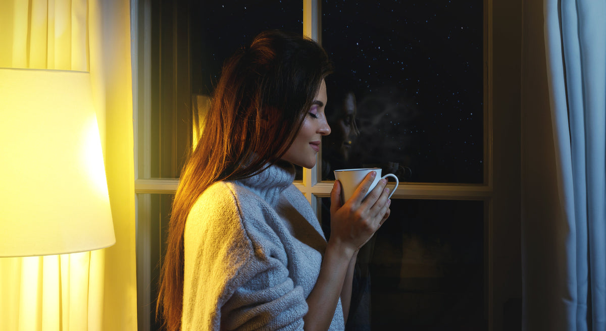Woman holding a hot coffee